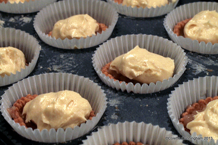 Sponge mixture on top of the fruit and pastry base, ready for the oven